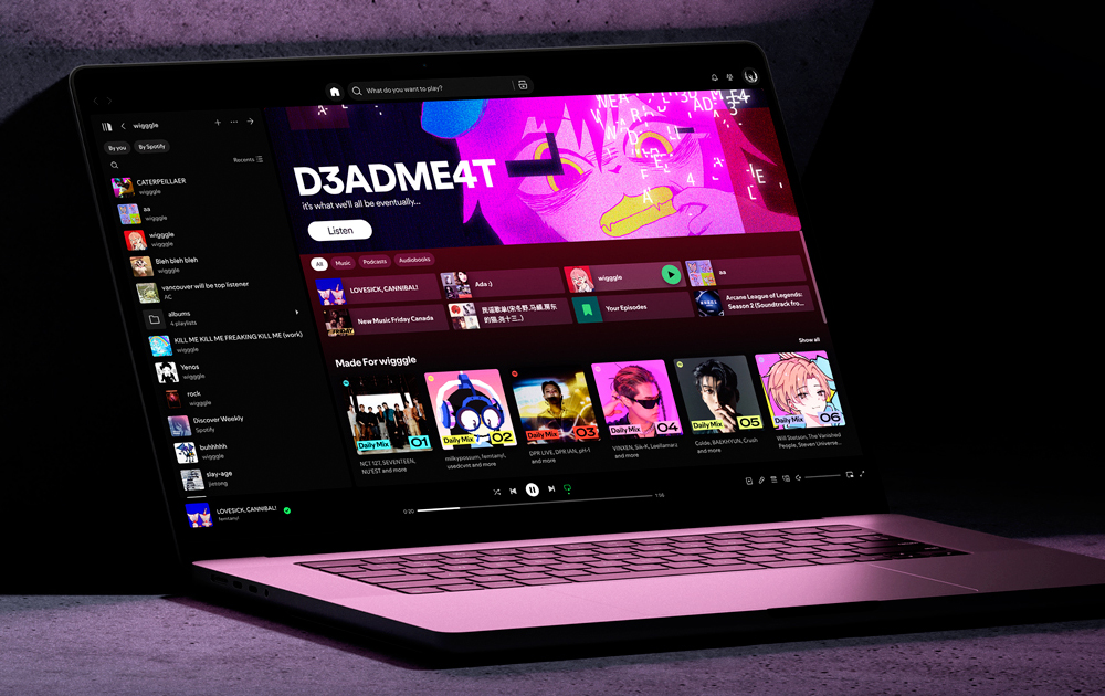 Laptop screen on the Spotify home page. The page banner has the D3ADME4T illustration and is illuminating the surroundings. The text reads "D3ADME4T it's what we'll all be eventually..."